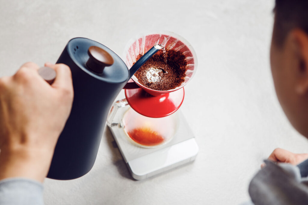 man making pour over coffee