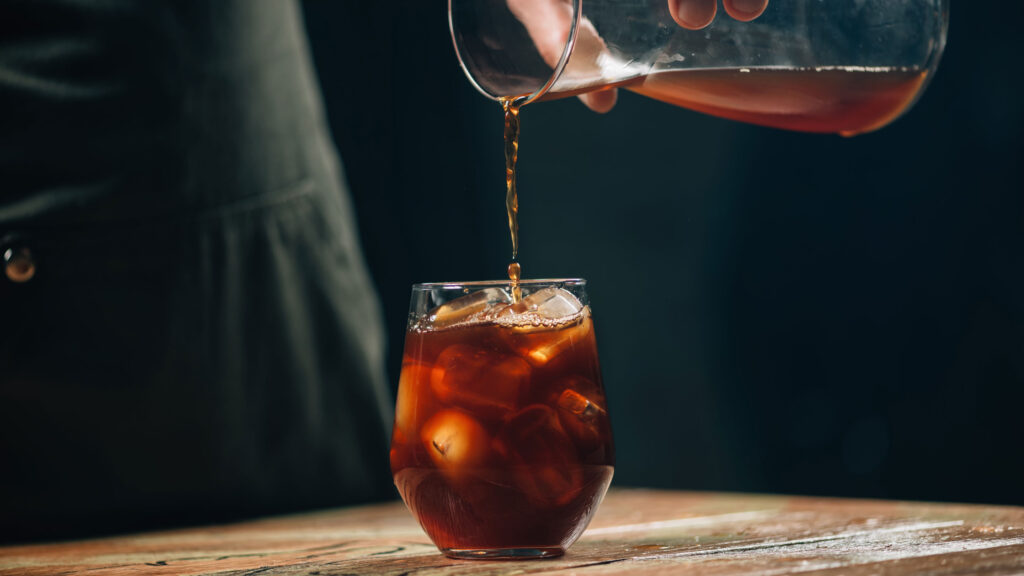 pouring cold brew into glass