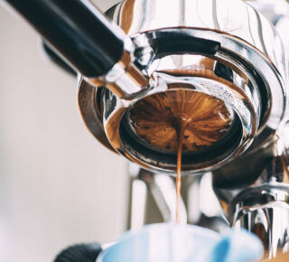 Espresso head brewing from underneath closeup