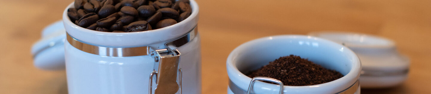 coffee stored in opaque canisters white with clamps