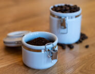 ground and whole bean coffee in opaque airtight canisters