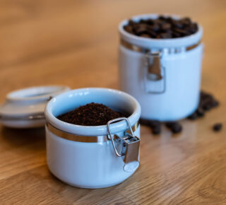 ground and whole bean coffee in opaque airtight canisters